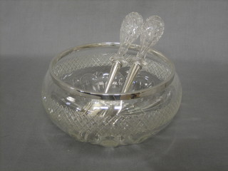 An  Edwardian cut glass salad/fruit bowl with silver rim  together with a pair of matching servers with silver prongs, London 1904