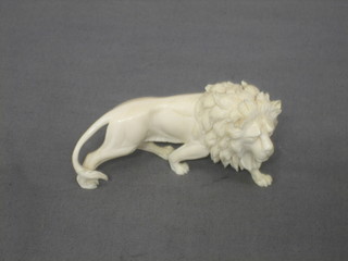 A carved ivory figure of a walking lion 3"