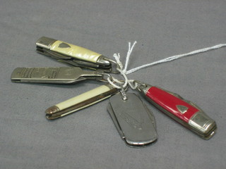A Guinness advertising pocket knife, a Seger's Special Gin pocket knife and 3 others