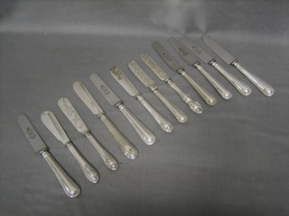 A collection of various silver plated butter knives