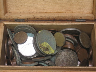 A small wooden box containing a collection of coins