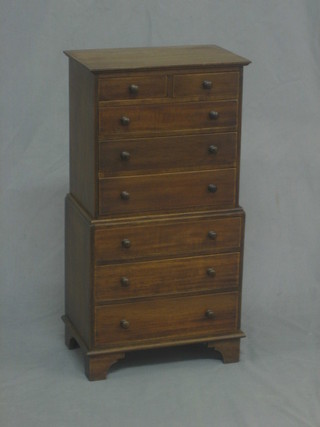 A reproduction Victorian miniature mahogany apprentice chest on chest fitted 2 short and 3 long drawers above 3 long graduated drawers, raised on bracket feet 12"