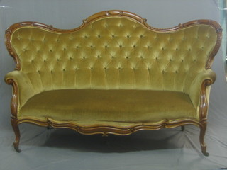 A Victorian mahogany show frame high back sofa upholstered in buttoned back gold Dralon, raised on cabriole supports 64" 