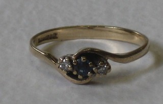 A lady's 9ct yellow gold dress ring set a sapphire supported by 2 diamonds