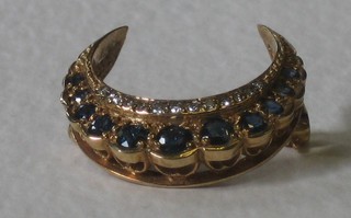 An Edwardian gold crescent shaped brooch set sapphires and diamonds