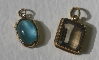 A rectangular cut quartz pendant contained in a gold mount together with an oval "turquoise" cabouchon cut pendant with gold mount