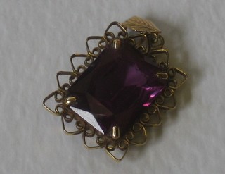 A rectangular "amethyst" pendant contained in a gold mount