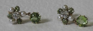 A pair of Edwardian cluster/drop earrings each set a diamond to the centre surrounded by peridot and pearls (screw backs)