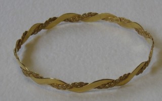An 18ct gold bangle