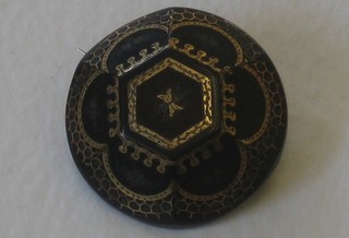 A circular piquet brooch