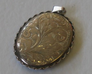 An oval engraved silver locket