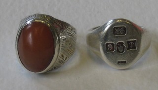 A silver signet ring and 1 other