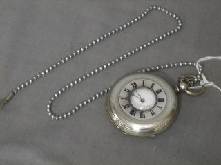 A demi half hunter key wind pocket watch contained in a "silver" case