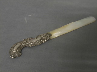 A Victorian silver handled letter opener with embossed silver handle and mother of pearl blade 8"