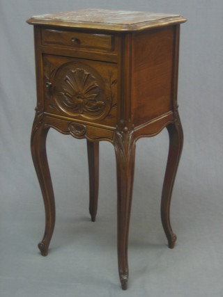 A 19th Century French carved walnut bedside cabinet of serpentine outline with pink veined marble top, fitted 1 long drawer above a cupboard, raised on cabriole supports 16"