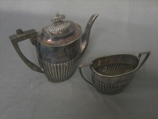 A Britannia metal coffee pot with demi-reeded decoration and a twin handled sugar bowl