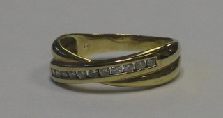 A gold cross-over dress ring set diamonds