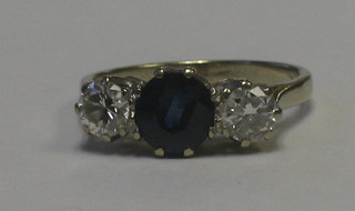 A lady's gold engagement/dress ring set a sapphire supported by 2 diamonds