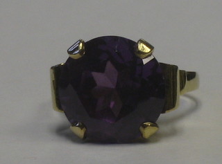 A 9ct gold dress ring set an oval cut purple stone