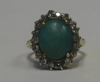 A lady's 18ct gold dress ring set a cabouchon cut turquoise surrounded by diamonds