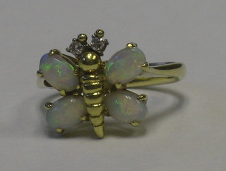 An 18ct gold dress ring in the form of an insect, the wings set opals and the eyes set diamonds