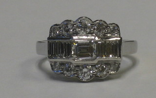 A lady's 18ct white gold dress ring set baguette cut diamonds supported by numerous diamonds approx. 0.89/0.55ct