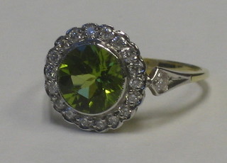 A lady's 18ct yellow gold dress ring set a circular Peridot supported by numerous diamonds