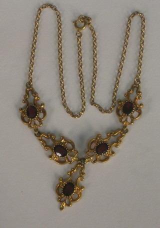 A 15ct gold necklet set garnets hung on a gold belcher link chain