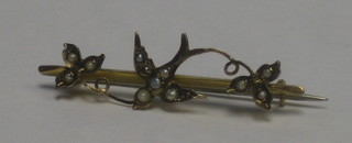 A 9ct gold bar brooch in the form of a dove set demi pearls
