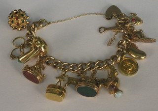 A 9ct gold curb link charm bracelet hung 13 various charms