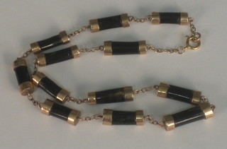 A black tubular bead and gold necklace