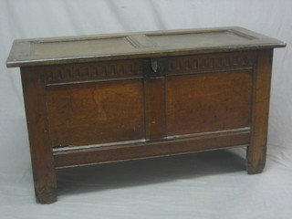An 18th Century oak coffer of panelled construction with hinged lid and iron lock 45"