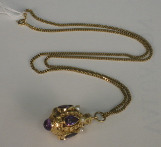 An 18ct gold charm set pearls and semi-precious stones hung on a 9ct gold chain