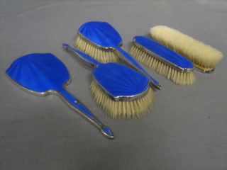 An Art Deco silver and blue enamel backed 5 piece dressing table set comprising pair of hair brushes, pair of clothes brushes and a hand mirror Birmingham 1933