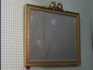 A rectangular bevelled plate wall mirror contained in a gilt frame surmounted by ribbon garland 22"