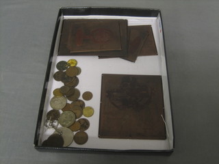 A small collection of coins and various copper printing plates