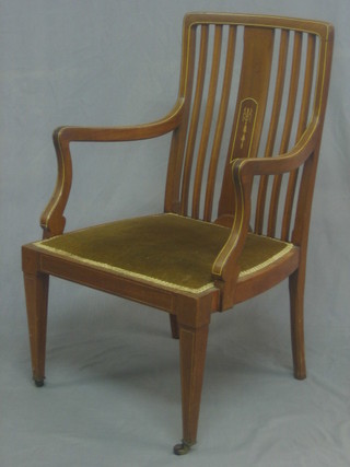 An Edwardian inlaid mahogany stick and bar back open arm chair raised on square tapering supports
