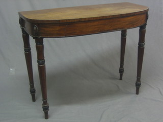 A Georgian mahogany D shaped side table raised on turned supports 36"