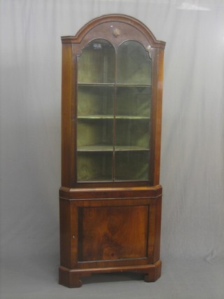 A Queen Anne style mahogany dome shaped double corner cabinet the upper section fitted shelves enclosed by astragal glazed door, the base fitted a cupboard and raised on bracket feet 28"
