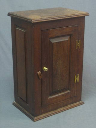 A hardwood cabinet enclosed by panelled door 19"