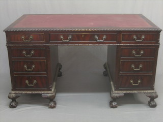 A Chippendale style kneehole mahogany pedestal desk with inset tooled leather writing surface, the frieze with 1 long and 2 short drawers the pedestals with 6 drawers, raised on cabriole claw and ball supports 54"