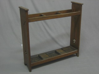 An Art Nouveau oak umbrella stand complete with drip trays 29"