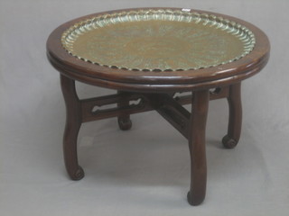 A circular Eastern hardwood table with inset copper tray decorated figures, raised on cabriole supports 31"