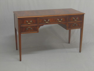 A Georgian style mahogany writing table fitted 1 long and 2 short drawers flanked by 4 short drawers, raised on square tapering supports 47"