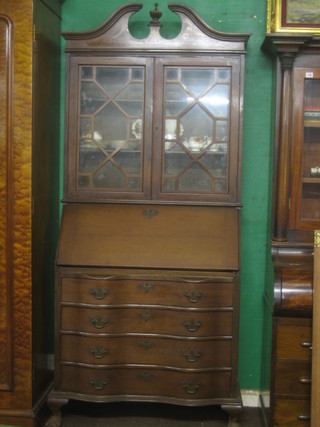 A Georgian style mahogany bureau bookcase with broken pediment, the upper section fitted shelves enclosed astragal glazed door, the fall front with well fitted interior, the base fitted 4 long drawers of serpentine outline, raised on cabriole supports 34"