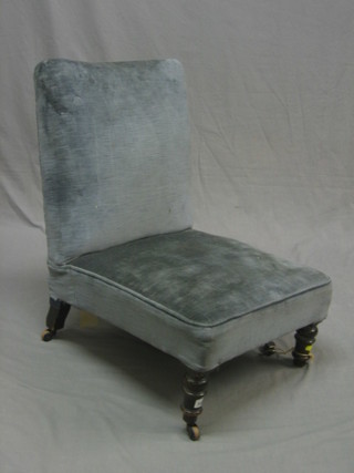 A Victorian mahogany framed nursing chair upholstered in blue material