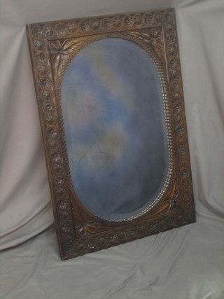 A Victorian oval bevelled plate wall mirror contained in a carved oak frame 40"