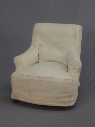 A Victorian mahogany armchair upholstered in floral material raised on turned supports