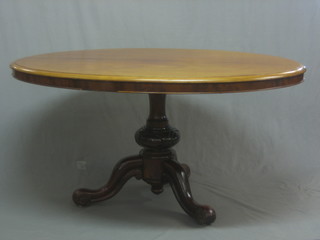 A Victorian walnut oval Loo table, raised on a pillar and tripod base 57"