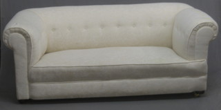 A Victorian mahogany framed drop end Chesterfield upholstered in white material 70"